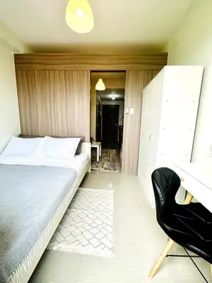 a bedroom with a bed and a black chair at OREO1232 House in Manila
