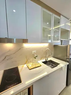 a kitchen with a sink and a counter top at Graceful Getaway Suites in Manila