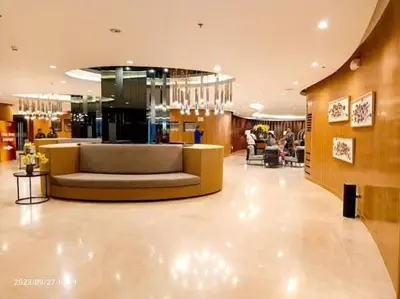 a lobby with a couch in the middle of a building at Graceful Getaway Suites in Manila