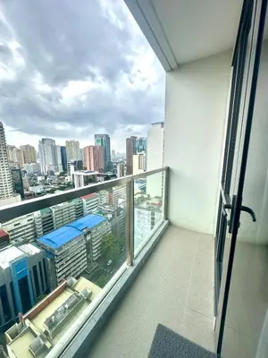 a balcony with a view of a city at Cozy 1BR at Greenbelt Hamilton Makati in Manila