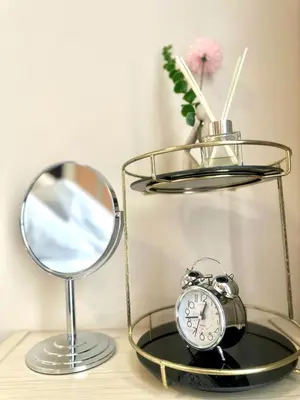 a mirror and a clock on a table at Cozy 1BR at Greenbelt Hamilton Makati in Manila