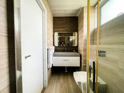 a bathroom with a sink and a mirror at Full-Serviced Residential Apartment in Uptown, BGC in Manila