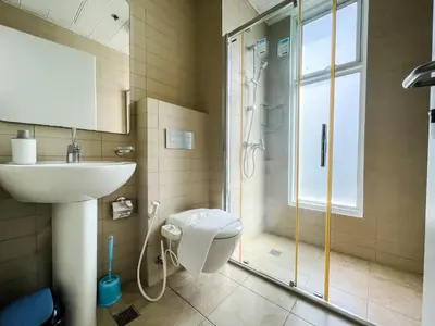 a bathroom with a shower and a sink and a toilet at Full-Serviced Residential Apartment in Uptown, BGC in Manila