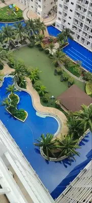 a model of a resort with palm trees and water at Carps Staycation in Manila