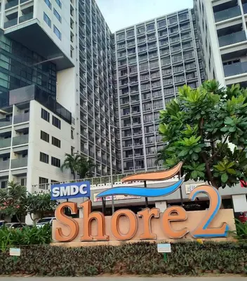a sign for a store in front of some buildings at Carps Staycation in Manila