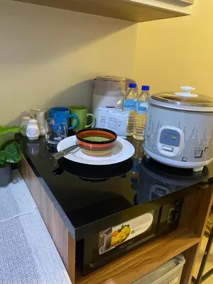a counter top with a pot and a bowl on it at Cozy studio unit 10mins from Airport 20mins from US Embassy across SM Sucat in Manila
