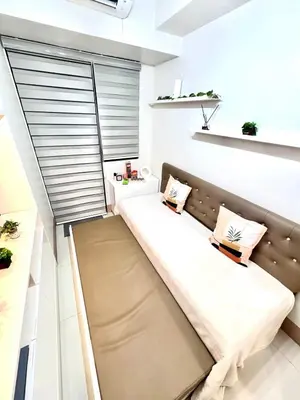a couch in a room with a window at Hearth of Ember 4 at Shore 3 Res in Manila