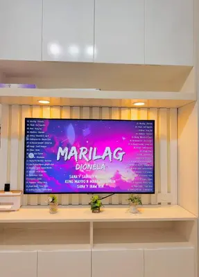 a large flat screen tv sitting on a shelf at Hearth of Ember 4 at Shore 3 Res in Manila