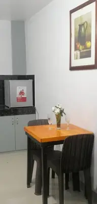 a wooden table with two wine glasses on top of it at Rosie's Staycation in Trece Martires, Cavite in Quintana
