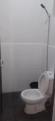 a bathroom with a white toilet in a stall at Rosie's Staycation in Trece Martires, Cavite in Quintana