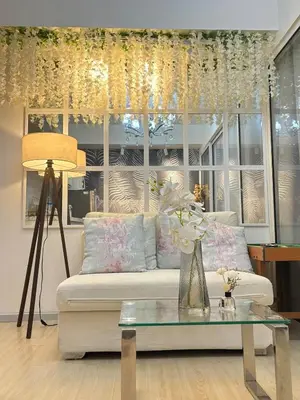 a living room with a white couch and a table at Home Sweet Home - Azure in Manila