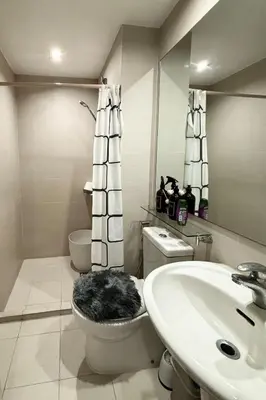 a bathroom with a toilet and a sink at Home Sweet Home - Azure in Manila