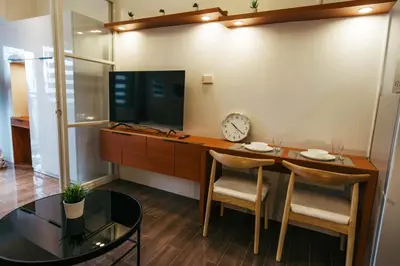 a dining room with a table and a tv at Modern Living 5 with Fast Wifi and Netflix in Manila