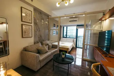 a living room with a couch and a table at Modern Living 5 with Fast Wifi and Netflix in Manila