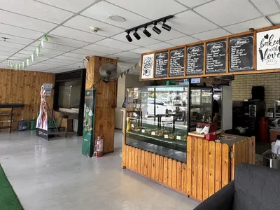 a fast food restaurant with a counter and a bakery at The Circuit Manor Hotel near Ayala Malls Circuit in Manila