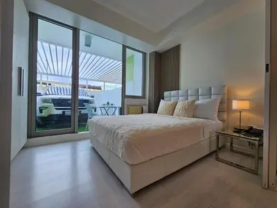 a bedroom with a bed and a large window at Rio Primea in Manila