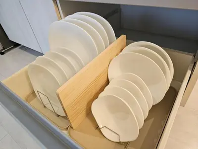 a group of white plates in a drawer at Rio Primea in Manila