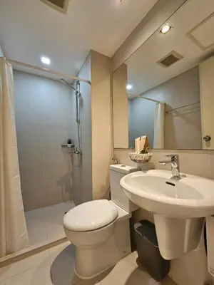 a bathroom with a toilet and a sink and a shower at Rio Primea in Manila