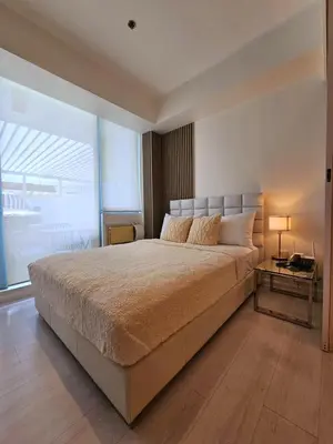 a large bedroom with a large bed and a table at Rio Primea in Manila