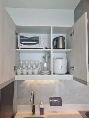 a kitchen with a sink and a microwave at Rio Primea in Manila