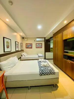 a hotel room with a bed and a tv at Casa Verde Hotel & Events Center in Imus