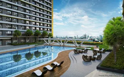 a swimming pool with lounge chairs and a building at Casa Melchor - Cozy Staycation in Manila
