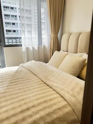 a large bed in a room with a window at Casa Melchor - Cozy Staycation in Manila