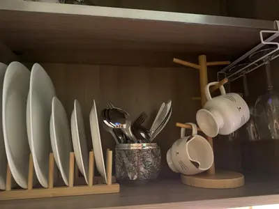 a shelf with a bunch of plates and utensils at Casa Melchor - Cozy Staycation in Manila