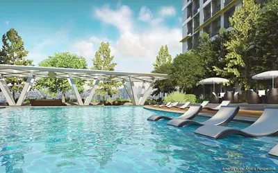 a swimming pool with lounge chairs and umbrellas at Casa Melchor - Cozy Staycation in Manila
