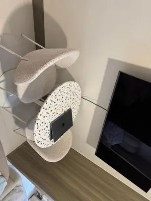 an apple device on a glass shelf next to a tv at Casa Melchor - Cozy Staycation in Manila