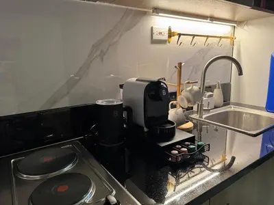 a kitchen with a sink and a coffee maker at Casa Melchor - Cozy Staycation in Manila