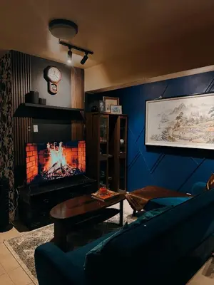 a living room with a couch and a fireplace at Moody Space near NAIA TERMINALS in Manila