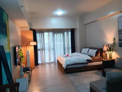a living room with a bed and a couch at M&N Condotel in Manila