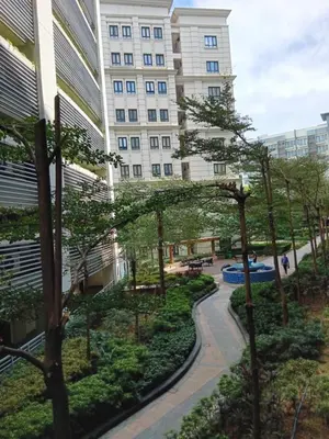 a view of a building with trees in front of it at M&N Condotel in Manila