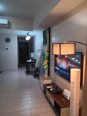 a living room with a flat screen tv on a wall at M&N Condotel in Manila