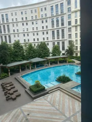 a large swimming pool in front of a building at M&N Condotel in Manila