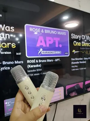 a person holding a wii remote and a microphone at Newly opened near MOA & Airport with PS4 and karaoke in Manila