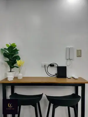 a desk with two green chairs and a phone at Newly opened near MOA & Airport with PS4 and karaoke in Manila