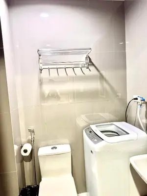 a small bathroom with a toilet and a sink at Makati City Oasis The Air Residences #2148 in Manila