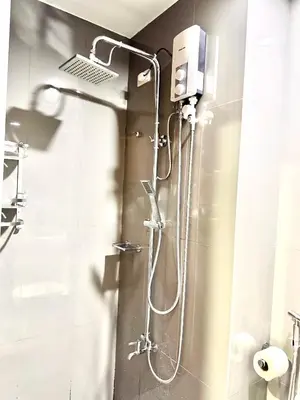 a shower stall in a bathroom with a shower at Makati City Oasis The Air Residences #2148 in Manila