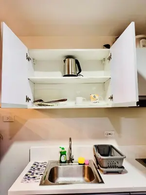 a kitchen with a sink and a stove at Makati City Oasis The Air Residences #2148 in Manila
