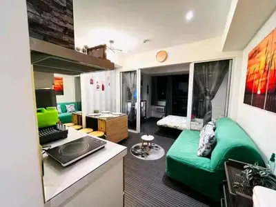 a living room with a green couch in a room at Azure Urban Resort Staycation By Yana in Manila