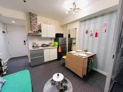 a kitchen with a counter and a table in it at Azure Urban Resort Staycation By Yana in Manila