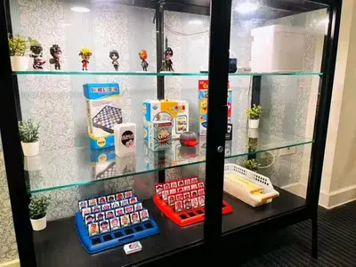 a glass display case with toys and other items at Azure Urban Resort Staycation By Yana in Manila