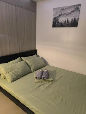 a bed with two pillows on top of it at Shore 2 Residences - La Casa in Manila