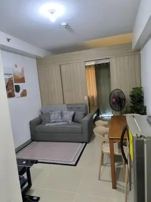 a living room with a couch and a table at Shore 2 Residences - La Casa in Manila