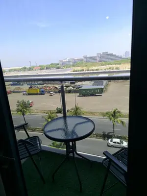 a table on a balcony with a view of a street at Shore 2 Residences - La Casa in Manila