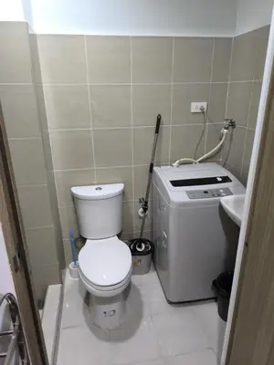 a small bathroom with a toilet and a sink at Shore 2 Residences - La Casa in Manila
