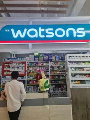 a man standing in front of a wissons store at Sleek 1 BR APT at FAME Residences with Balcony in Manila