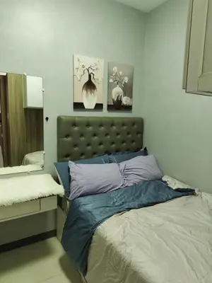 a bedroom with a bed and a mirror at ck staycation coast residence in Manila